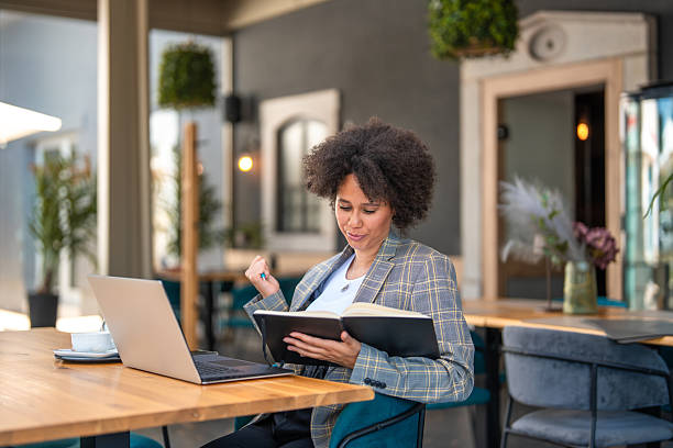 istock Mid Adult Entrepreneur Reviewing Notes in Modern Workspace 2224906022