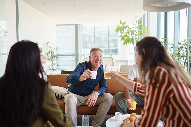 istock Cheerful Diverse Coworkers Enjoying Drinks in Office Lobby 2224907484