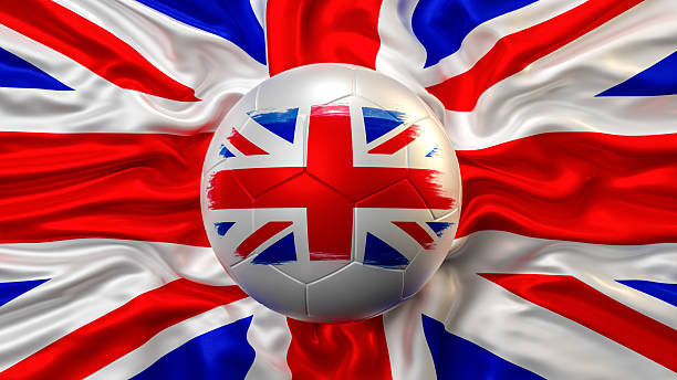A patriotic sports graphic celebrating UK football, with a soccer ball featuring a painted Union Jack flag resting on a larger draped British flag. This 3D illustration is a powerful symbol of national pride and support for the British home nations in major international soccer tournaments. It's perfect for fans, sports media, and promotions during the World Cup or European Championships.