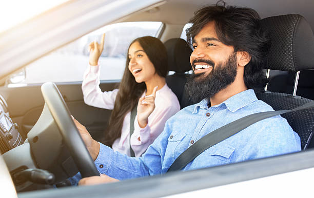 istock Indian couple laughing and dancing inside car while driving, enjoying upbeat moment 2224909440