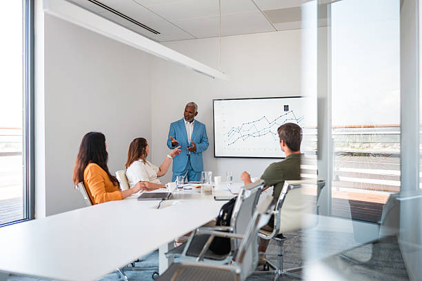 istock Mature Hispanic Business Expert Leading Team in Modern Office 2224909695