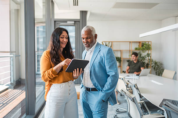 istock Caucasian Employee and Hispanic CEO Discussing Digital Strategy in Office 2224909798