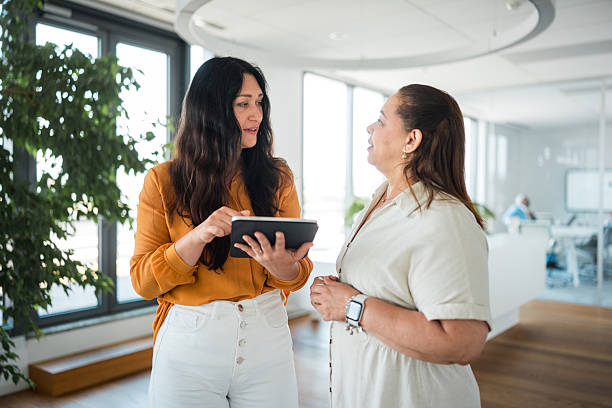 istock Caucasian Businesswomen Collaborating with Digital Tablet in Modern Office 2224909806