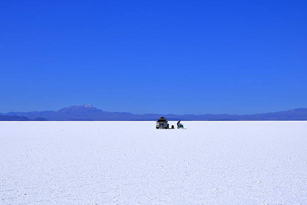 Uyuni in Bolivia - May 27 2025: people explore the salt flat by car