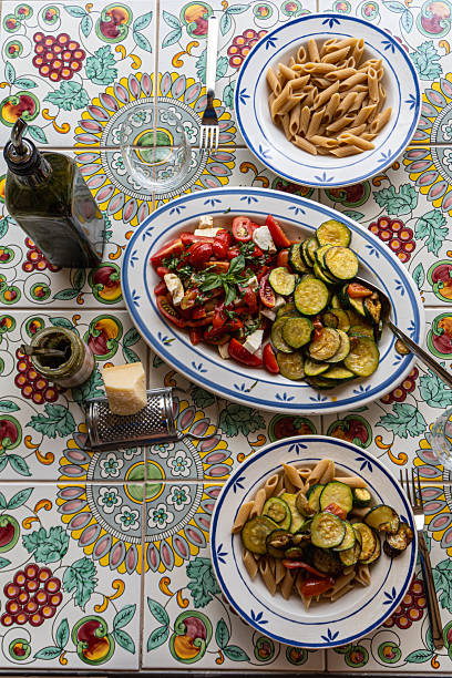 Overhead view of traditional Italian vegetarian meal on tiled table