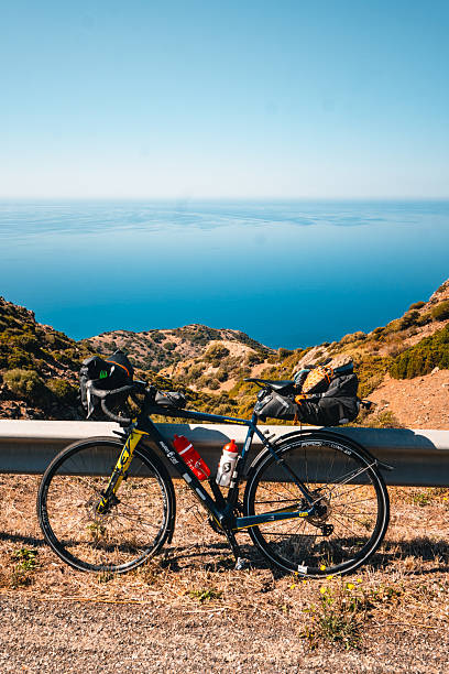 istock Bicycle with camping gear parked at viewpoint above sea 2224912259