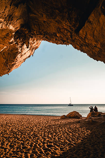 istock View through arch to beach and sea at sunset 2224913794