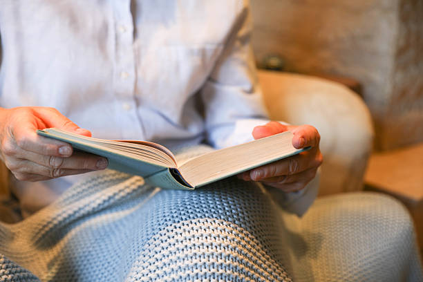 istock Close-Up Of Hands Holding Open Book 2224915203