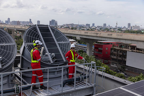 Engineers is checking the industry cooling tower air conditioner is water cooling tower air chiller HVAC  of a major building or industrial facility.