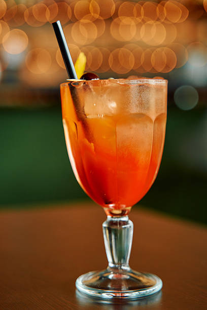 istock Refreshing citrus cocktail with straw and cherry garnish in elegant glass 2224916027