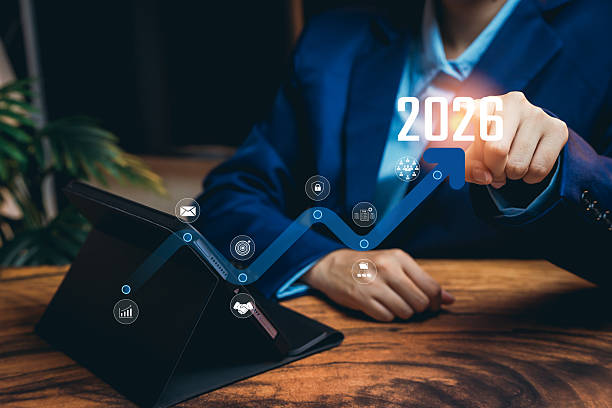 istock Business Professional Pointing at Future Growth Projection for 2026 with Digital Interface and Tablet on Wooden Desk 2224918938
