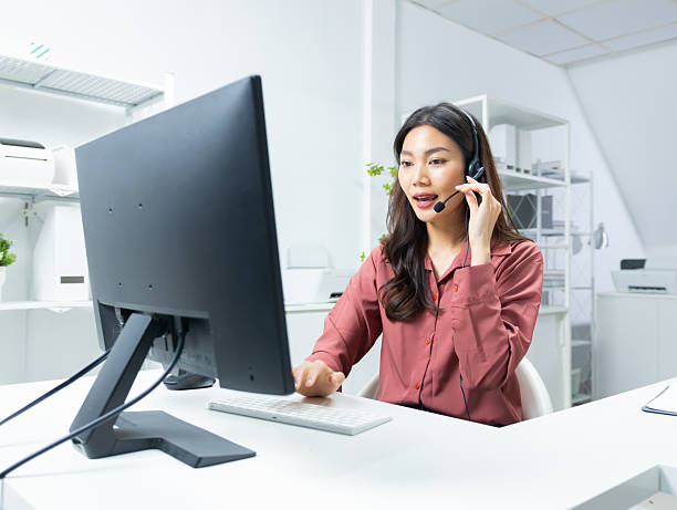 istock Asian Female Customer Support Agent Wearing Headset and Working,  giving support to customer at Virtual help desk in office. 2224922431