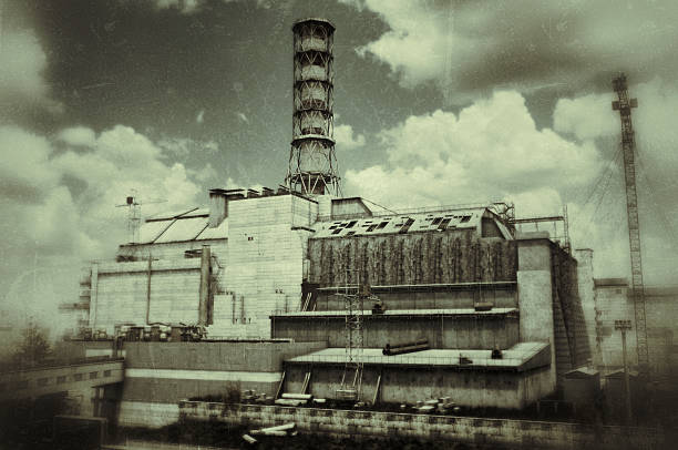 Dark and sulking image depicting he Chernobyl Nuclear Power Plant (CNPP) Reactor 4, captured in a somber, sepia-toned aesthetic that enhances its eerie, abandoned atmosphere. The reactor's iconic structure stands prominently, featuring a tall, cylindrical chimney-like tower with a lattice framework, surrounded by the weathered concrete sarcophagus that encases the damaged reactor. The building shows signs of decay, with cracked walls and rusted scaffolding, while the cloudy sky above adds to the desolate mood. The image conveys the historical significance and haunting legacy of the 1986 nuclear disaster.