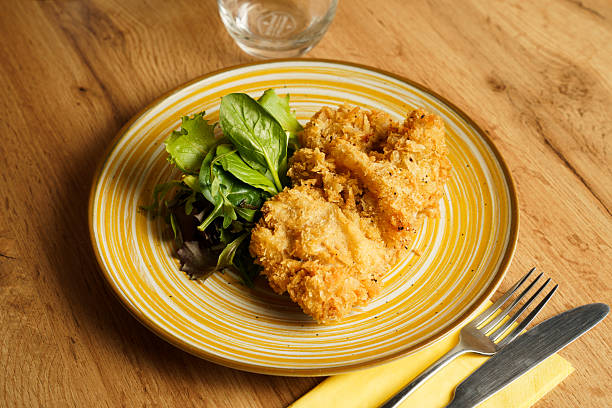 istock Crispy fried chicken with fresh salad greens 2224925603