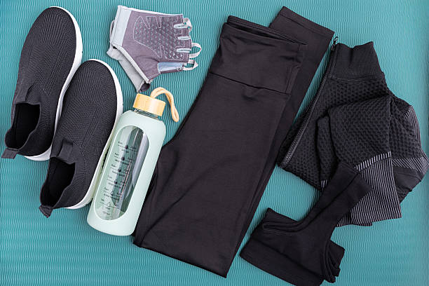 istock Fitness apparel and accessories laid out on a blue background. 2224926323