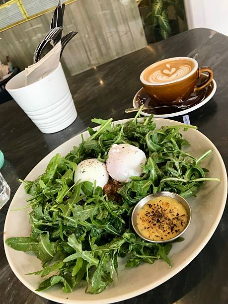 Rocket salad with poached eggs and coffee