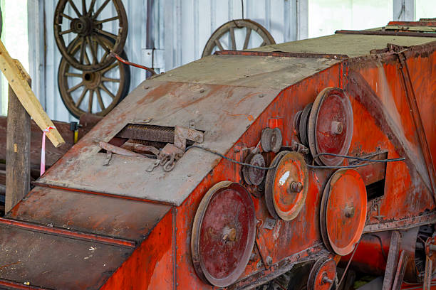istock Old agricultural threshing machine from the communist era, rusty and dusty, with visible pulleys and belts 2224928302