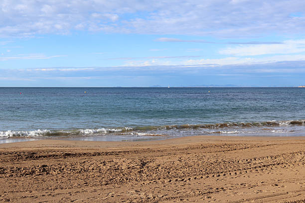 istock Tranquil beach waters with gentle waves and sandy shore 2224933997