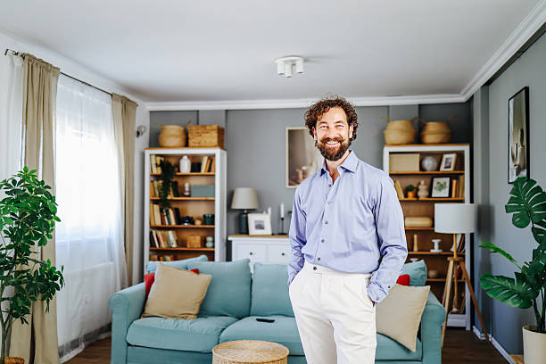 istock Smiling man posing in modern living room at home 2224934091