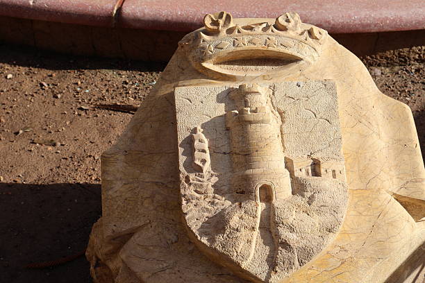 An intricately carved stone emblem features a historical design that reflects cultural significance. The craftsmanship and detail capture the essence of the region’s heritage. This emblem adds a unique element to the surrounding environment, inviting curiosity and admiration from onlookers.