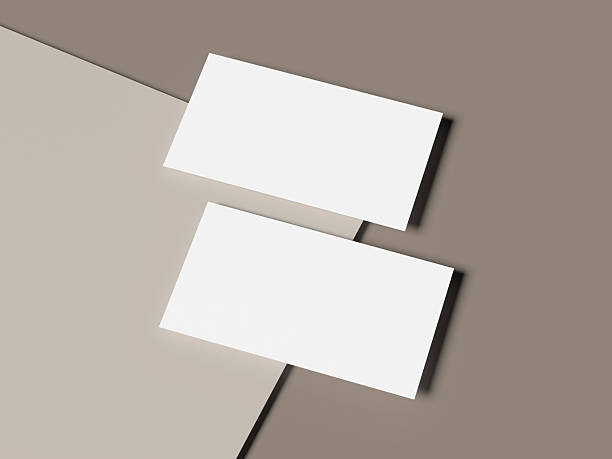 istock Floating white business cards on overlapping beige paper background 2224937534