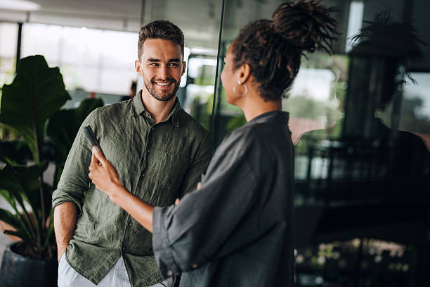 istock Multiracial colleagues discussing startup project and smiling during workday in office interior 2224941449