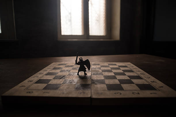 Medieval battle scene with cavalry and infantry on chessboard. Chess board game concept of business ideas and competition and strategy ideas Chess figures on a dark background with smoke and fog.