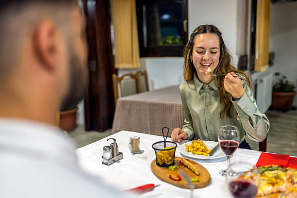 istock Young Couple Enjoying Pizza and Fried Chicken on a Romantic Date 2224942870