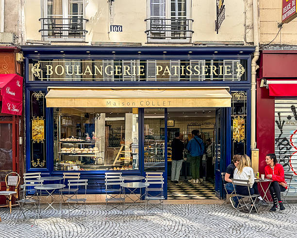 Paris, France - MAY 08, 2025: People eat and drink at a local cafe, on the street of Paris, France.