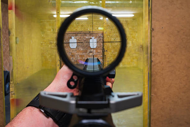 istock First-person view (POV) through a rifle's optical sight while aiming at paper targets at a shooting range. 2224946209