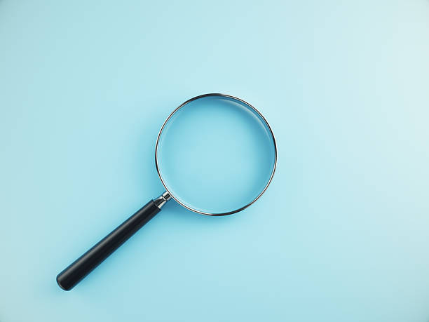istock Magnifying Glass on blue Color background 2224946499
