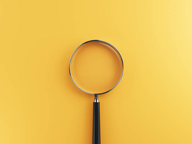 istock Magnifying Glass on Yellow-Orange Color background 2224946518