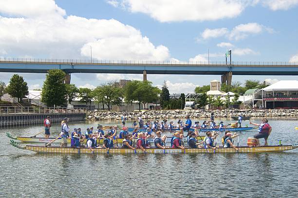Nuertingen, Germany - July 16, 2011: A group of disguised athletes on their boat at the anual dragon boat race on the river Neckar in Nuertingen in Germany on a sunny day in July 2011.
