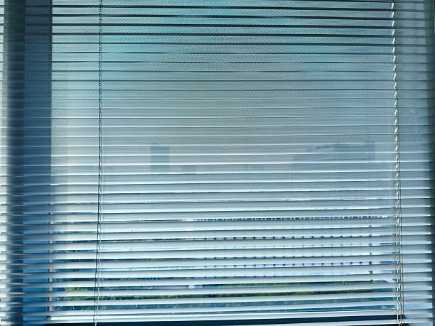 istock Close-up View of a Window with Aluminum Blinds Partially Open 2224954438