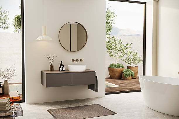 istock Contemporary minimalist bathroom captured from above, showcasing a harmonious layout with an oval bathtub, textured rug, and natural light. The soft earth tones bring warmth and calm. 3D top-down visualization. 2224954570