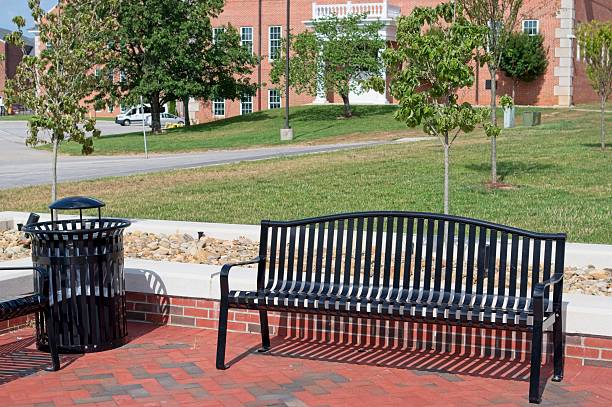 istock Iron bench and trash can in a small park 2224954880