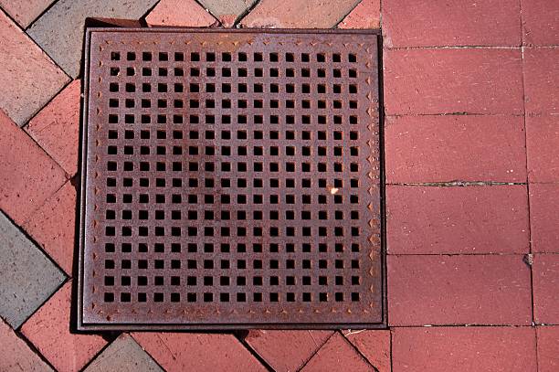istock Storm water drain with grate and brick 2224954887