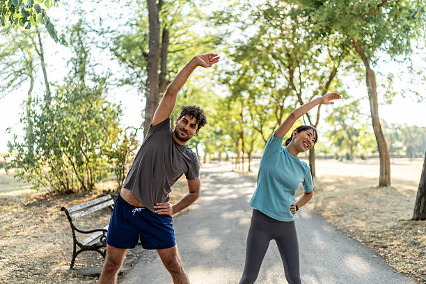 istock Young couple stretching together in a park before running 2224956174