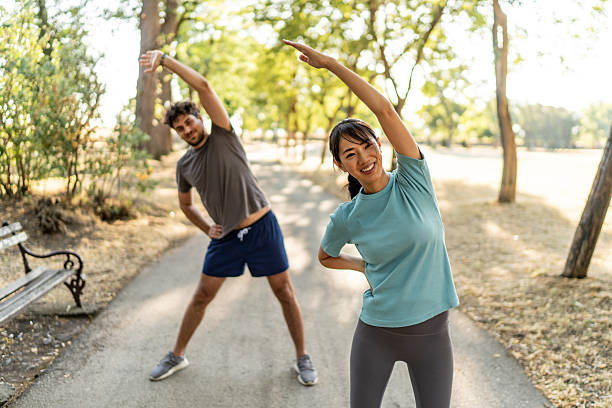 istock Young couple stretching together before exercising in the park 2224957167