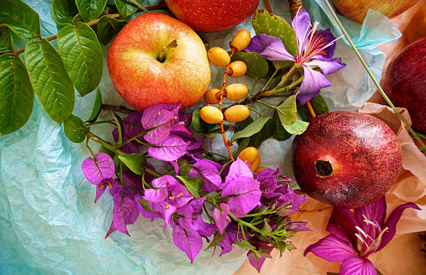 Beautiful still life with fruit, seeds, flowers and leaves on the light table