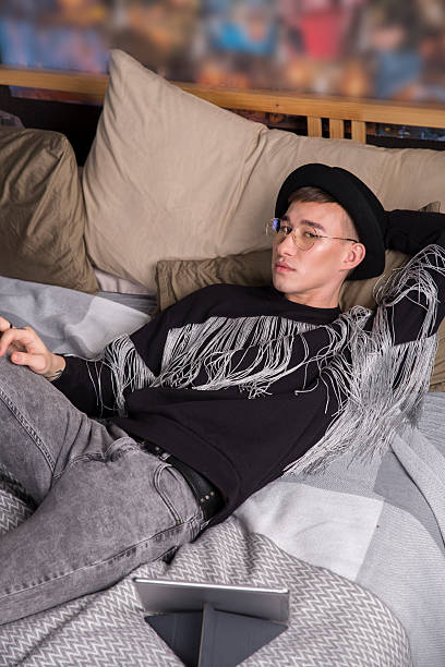 istock A young man in a black fringe sweater 2224959181