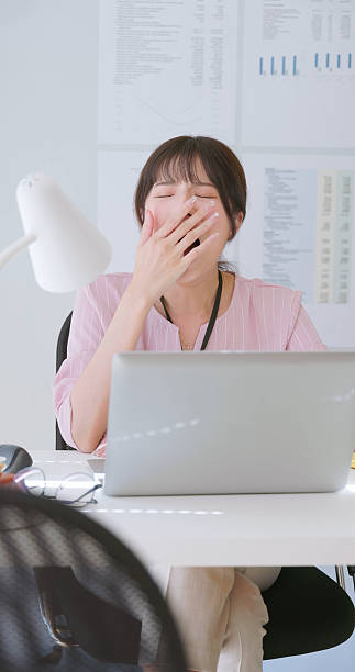 istock asian woman yawn at work 2224960554