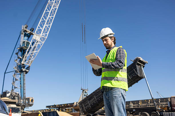 istock Port worker with tablet at cargo port with ship 2224960610