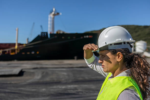 istock Port worker supervising the unloading of cargo from a ship at the port 2224960657