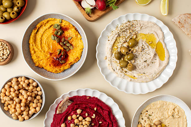 istock Different types of hummus in bowls and plates. Beetroot, pumpkin, chickpea and bean hummus. 2224965555