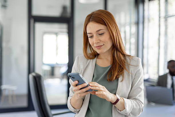 istock Focused woman working on her smartphone in an office 2224966067
