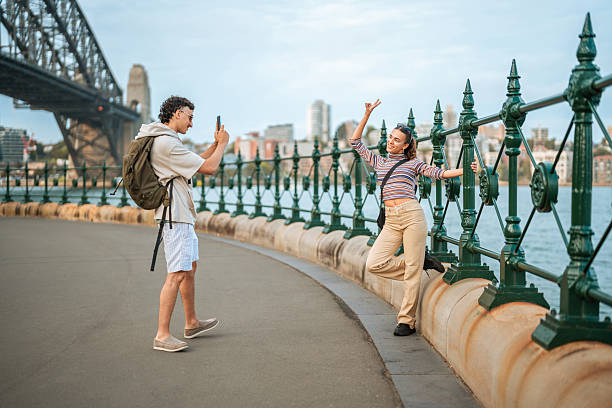 istock Cheerful Hispanic Couple Posing by Sydney Harbour Bridge 2224967336