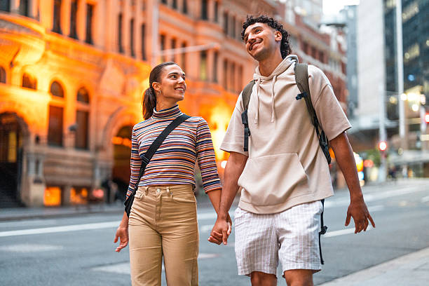 istock Smiling Hispanic Couple Strolling Sydney Streets During Twilight 2224967365