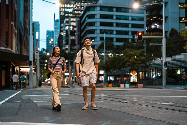 istock Curious Young Hispanic Couple Strolling in Sydney Streets at Dusk 2224967366