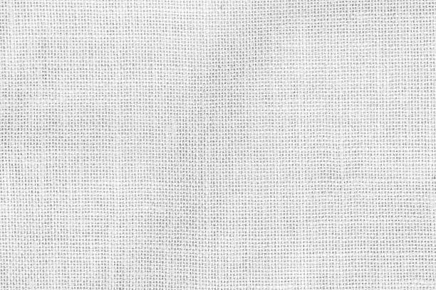 istock White hessian sackcloth woven with jute burlap cotton hemp fabric cloth textile texture pattern background in white light color 2224967413